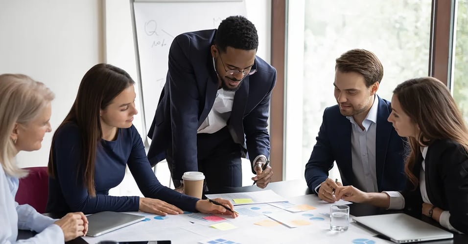 Business professionals meeting gathered around table