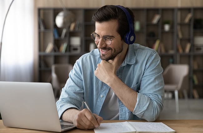 Man wearing headphones having fun in computer class