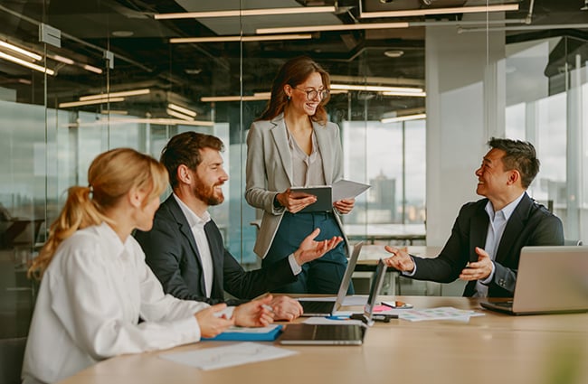 people-smiling-at-meeting-conference-room-as-941242530-650x425
